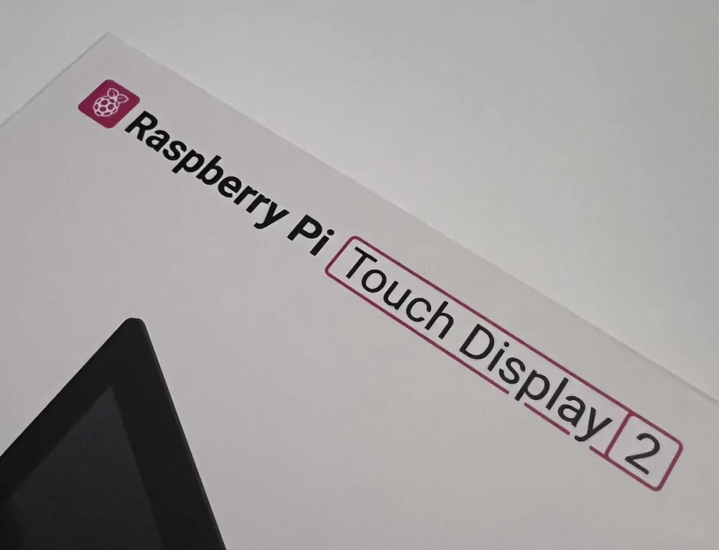 Raspberry Pi Touch Display 2 10 inch stood upright with a Raspberry Pi 5